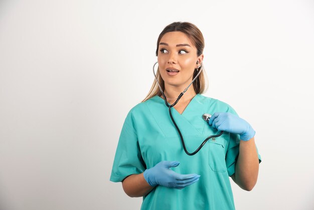 Young female nurse posing with stethoscope.