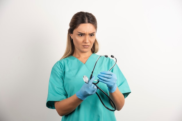 Young female nurse posing with stethoscope.