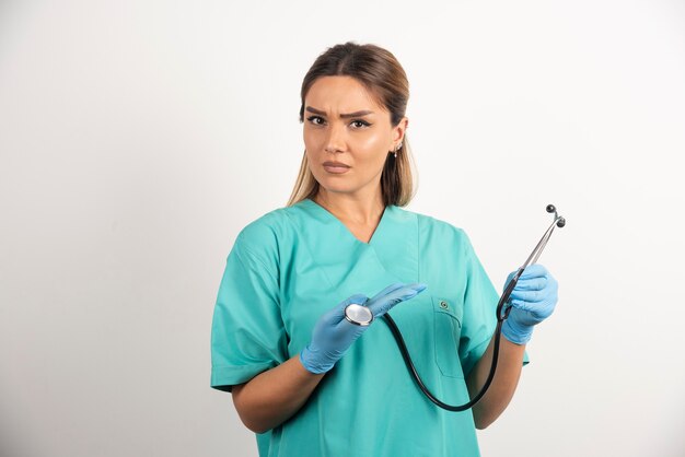 Young female nurse posing with stethoscope.