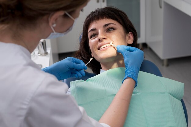 Young female patient having dental procedure at the orthodontist