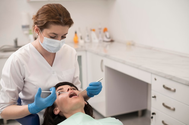 Young female patient having dental procedure at the orthodontist