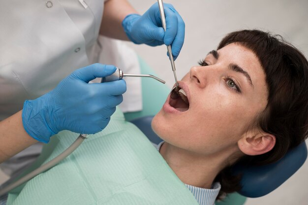 Young female patient having dental procedure at the orthodontist