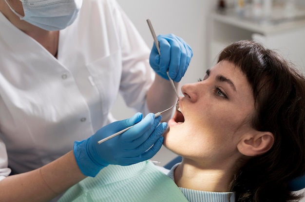 Young female patient having dental procedure at the orthodontist