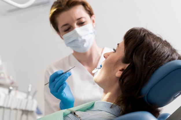 Young female patient having dental procedure at the orthodontist