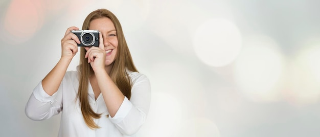 Young female photographer shooting with a film camera