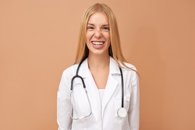 Young female physician with straight blonde hair and stethoscope around her neck