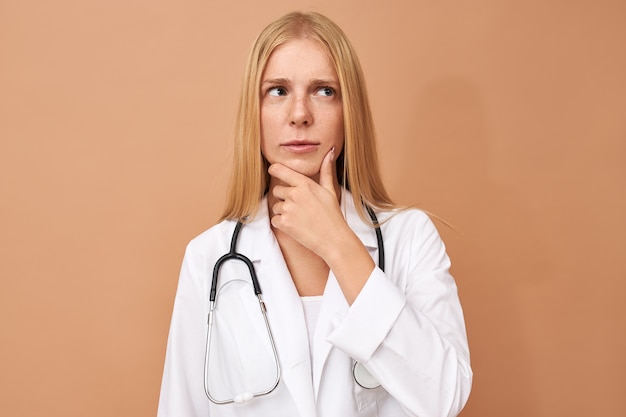 Young female physician with straight blonde hair and stethoscope around her neck