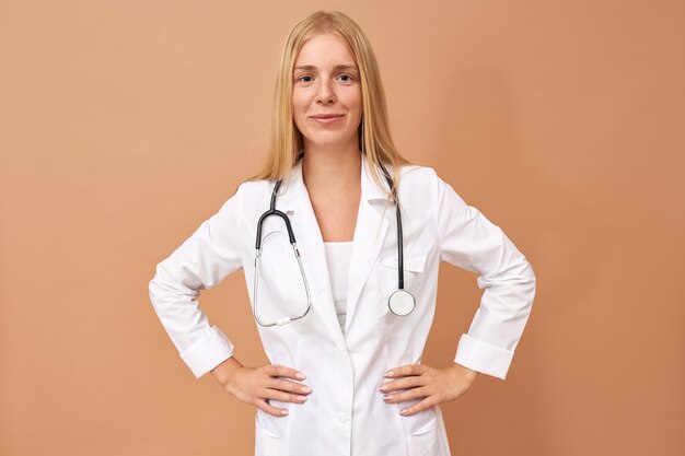 Young female physician with straight blonde hair and stethoscope around her neck