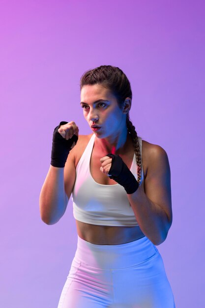 Young female practicing kickboxing