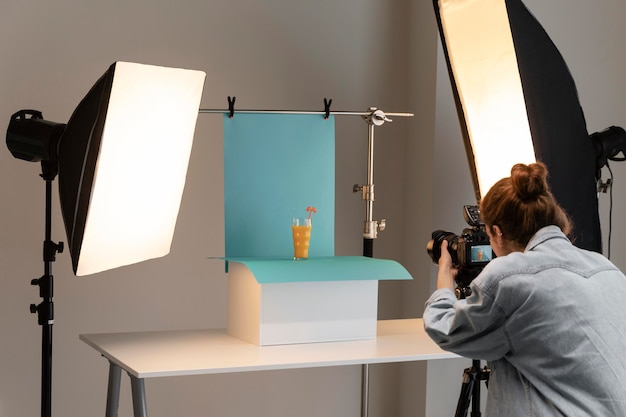 Young female product photographer in studio