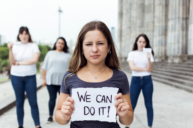 Free photo young female protesters marching together