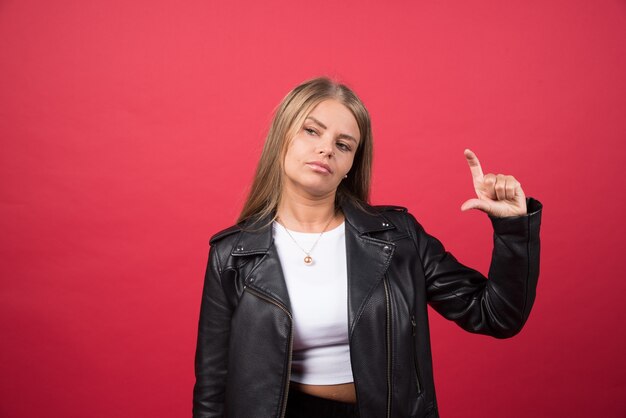 A young female showing something small in size with hands