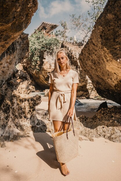 A young female standing next to the cliffs during daytime