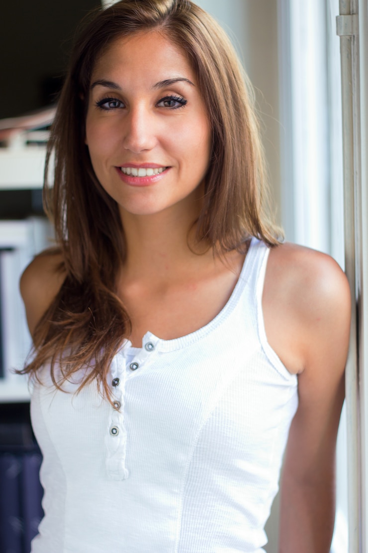 Free Photo young female standing near window at home