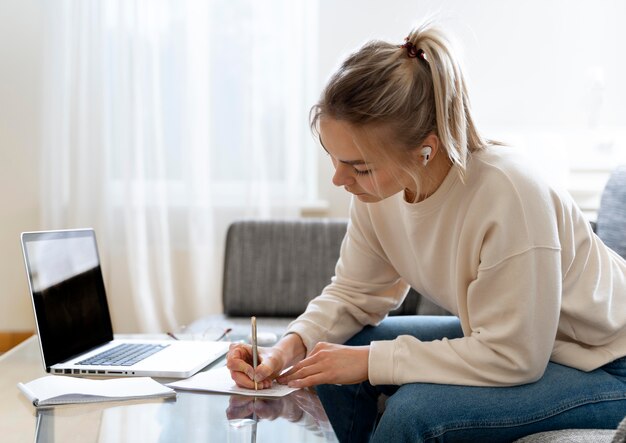 Young female student listening to her english teacher