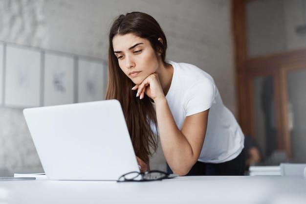 Young female student paying her house bills online looking sad Time to become more eco friendly