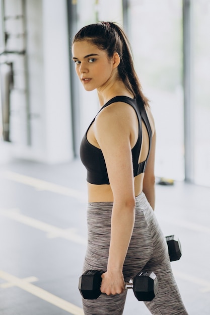 Young female trainer exercising at the gym