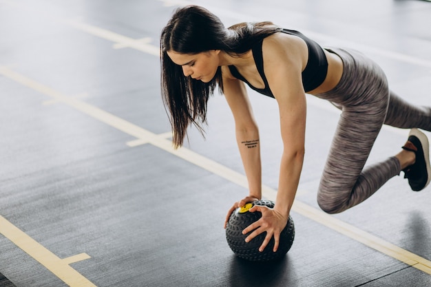 ジムで運動する若い女性トレーナー