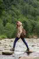 Free photo young female traveler enjoying rural surroundings