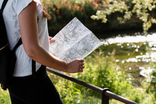 Free photo young female traveler with map