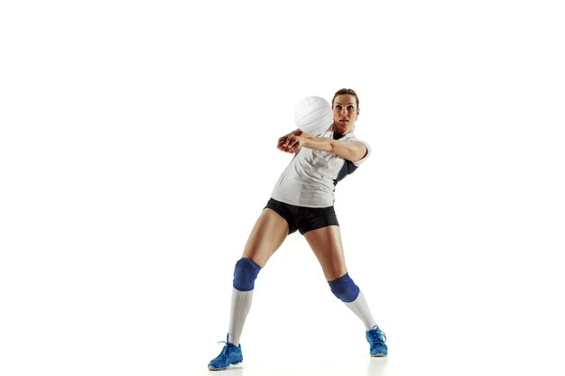 Young female volleyball player isolated on white  background.