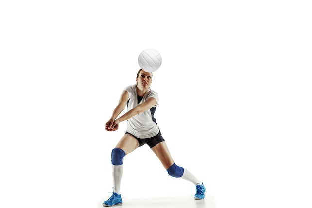 Free photo young female volleyball player isolated on white studio background. woman in sport's equipment and shoes or sneakers training and practicing. concept of sport, healthy lifestyle, motion and movement.