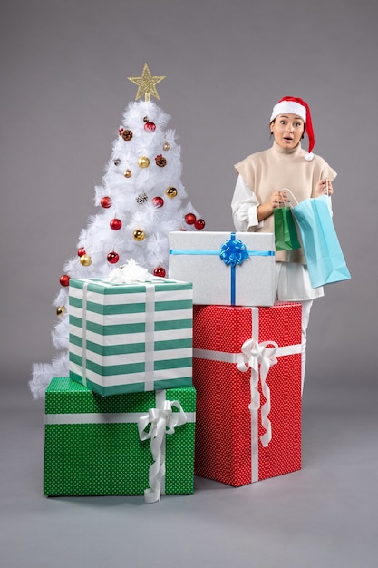 young female with christmas presents on light