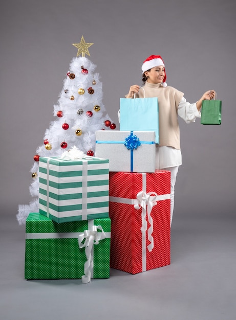 young female with christmas presents on light