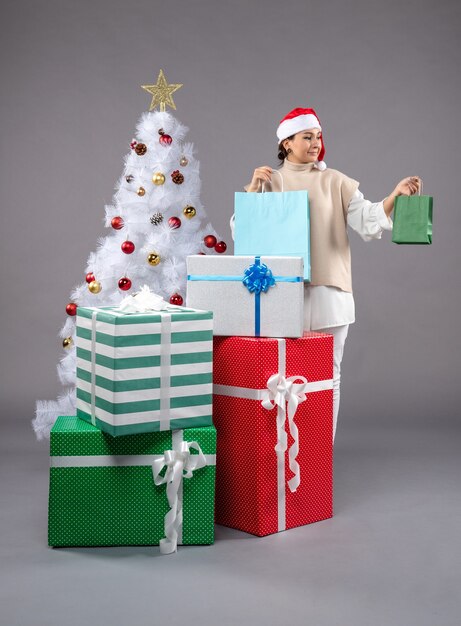 young female with christmas presents on light