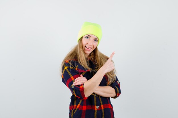 Young female woman in a checkered shirt with a hat