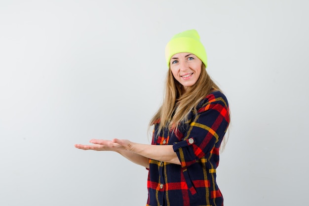 Young female woman in a checkered shirt with a hat