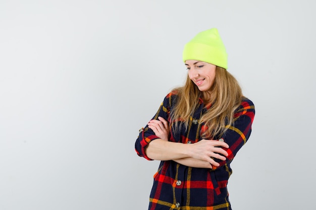 Young female woman in a checkered shirt with a hat