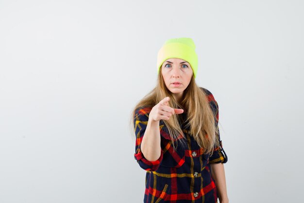 Young female woman in a checkered shirt with a hat