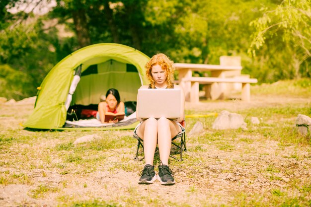 Young female working on laptop in rural