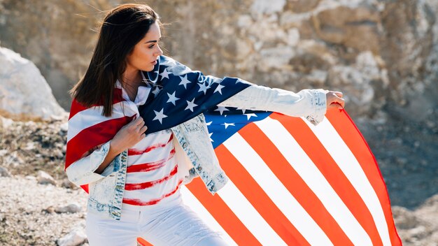 Young female wrapped in flag looking away