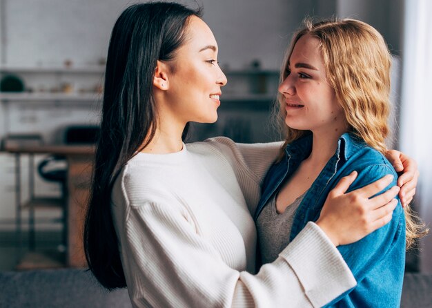 Young females smiling at each other