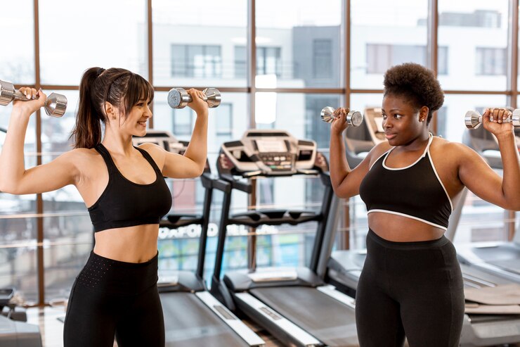 Free Photo young females training with hands weights