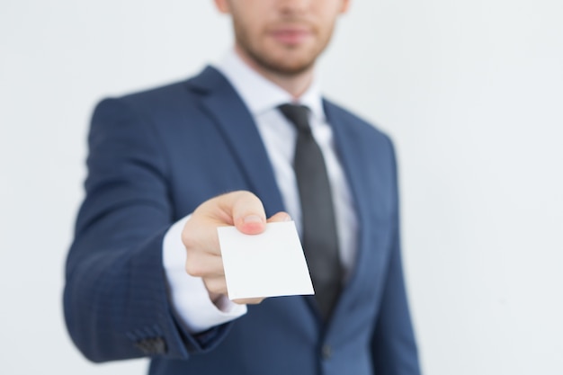 Young financial advisor giving business card