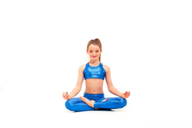 young fit girl doing yoga exercises on white