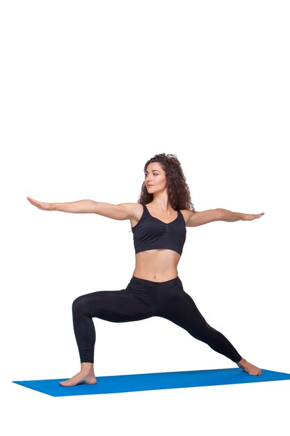 young fit woman doing yoga exercises.