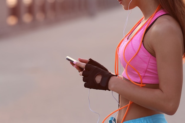 Young fit woman in sportswear outdoors