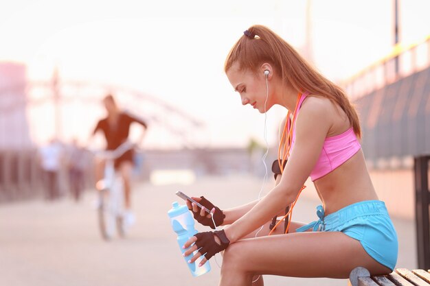 Young fit woman in sportswear outdoors