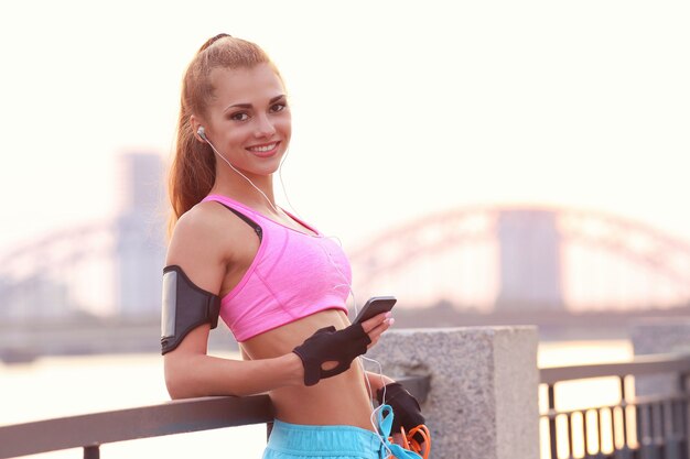 Young fit woman in sportswear outdoors