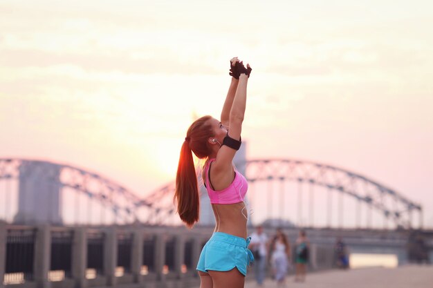 Young fit woman in sportswear outdoors