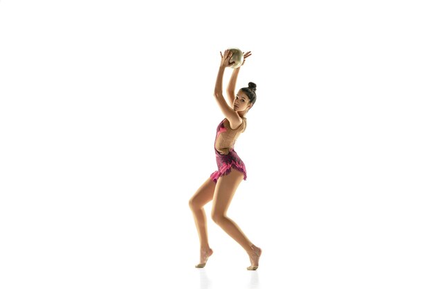 Young flexible girl isolated on white  background. Teen-age female model as a rhythmic gymnastics artist practicing with equipment.