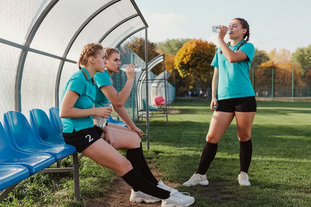 Young football players drinking water