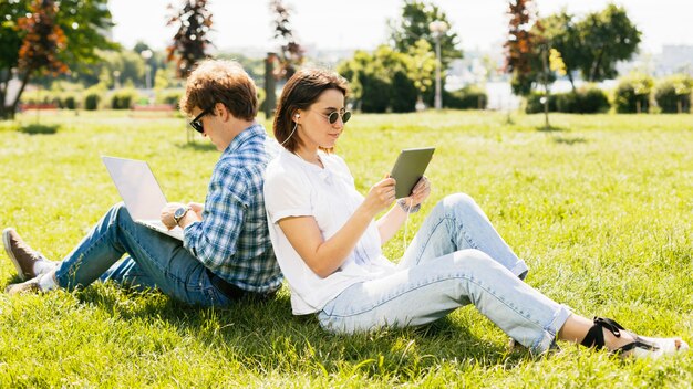 Young freelancers couple in the park
