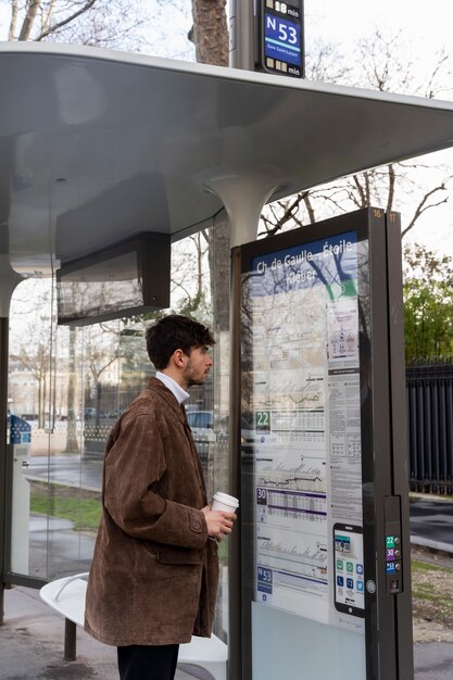 バス停の地図を参照して若いフランス人