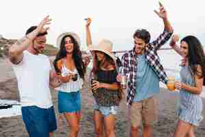 Free photo young friends celebrating at the beach