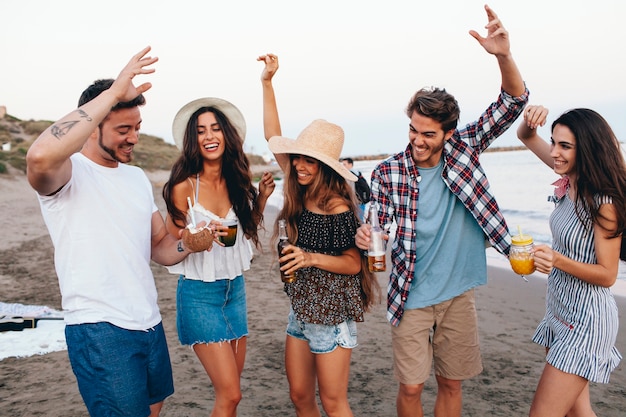 Young friends celebrating at the beach